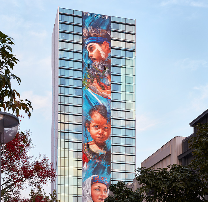 A tall building with an art mural down the centre